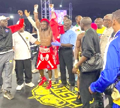 Referee Shadrach Acquaye raises Charles Tetteh's hands to declare him winner of last Saturday's fight