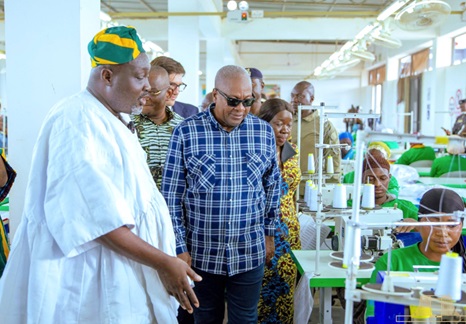 President John Dramani Mahama being conducted around the facility by Alhaji Nurideen Mohammed (left), CEO, Northshore Apparel Hub