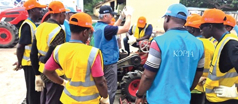 Mr Woong-Jae Lee (middle), an agricultural machinery specialist, demonstrates the operation of farm equipment to participants during the three-day farm machinery training programme