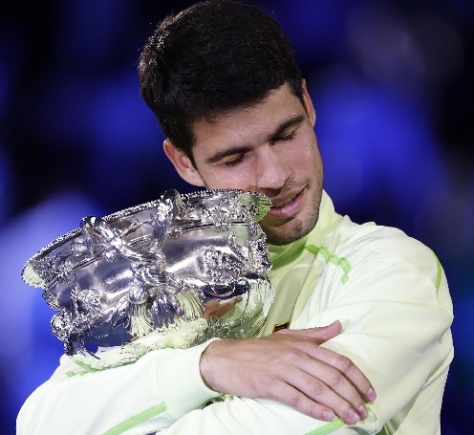 Carlos Alcaraz celebrating with his Australian Open trophy