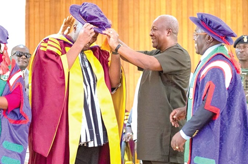 President Mahama decorating Ibrahim Mahama with a doctoral hat