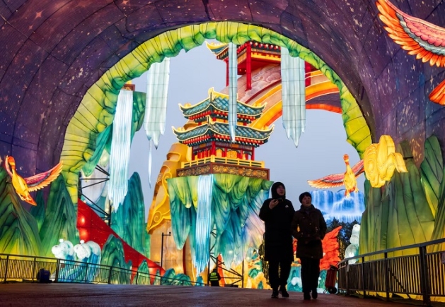 A couple walk in a tunnel inside a light installation at the 32nd Zigong International Lantern Festival ahead of the Chinese Lunar New Year, which will welcome the Year of the Horse, in Zigong, Sichuan province, China, January 23, 2026. REUTERS/Maxim Shemetov