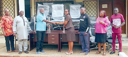 Dr Michael Mensah (2nd from left), MCE, Ayawaso West Municipal Assembly, presenting the items to Judith Amoateng Anning, Director of Education, Ayawaso West Municipal Education Office. Picture: ERNEST KODZI 