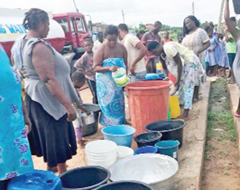 Ghana Water Company Limited tanker supplying water to a community