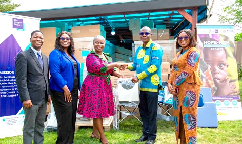 Agatha Quayson (middle), Country Leader of THP-Ghana, presenting the medical supplies to Frederick Owusu (2nd from right) and Evelyn Amoako (right), as Ezra Otoo (left) and Madam Marian Esiape of LDS look on