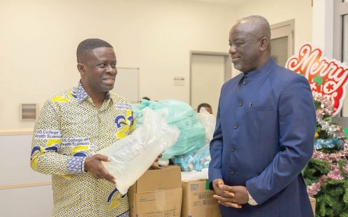 Prof. J.E Mensah (left), Head of the Urology and Nephrology Centre of Excellence, expressing his appreciation after receiving the items from Rev. Dr Joseph Kofi Antwi