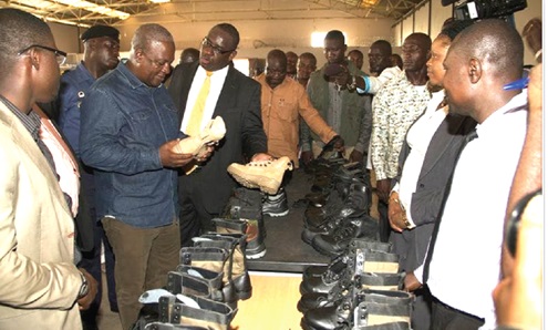 FLASHBACK: President John Dramani Mahama (2nd from left) examining some of the shoes produced at the factory when he visited in 2014