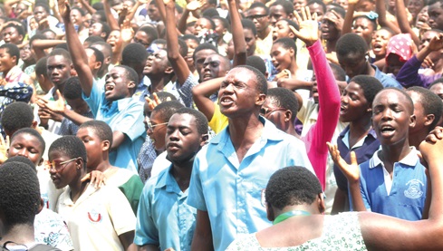 Some students praying and worshiping God during the National Youth Rally at the National Cricket field, Achimota School. Picture: ESTHER ADJORKOR ADJEI  
