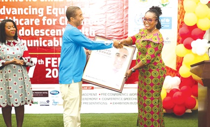 Rita Akosua Adjei Awatey (right), Eastern Regional Minister, presenting the citation to Alberto Mario Noretti, the Volta Regional correspondent of the Daily Graphic