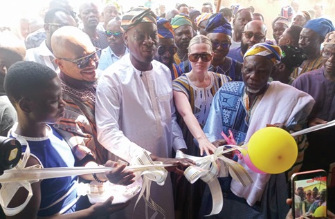 Haruna Iddrisu (middle), Minister of Education, being supported by Naa Ziblim Abdulai (right), Paramount Chief of Banvim, and other officials to inaugurate the facility