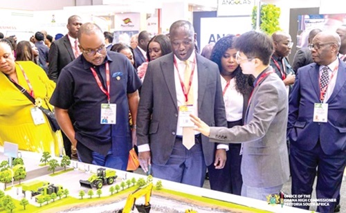 Emmanuel Armah-Kofi Buah (middle), Minister of Lands and Natural Resources, and the Ghana delegation interacting with an investor at the 2026 Mining Ndaba in South Africa