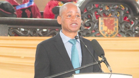 Dr Divine Ndonbi Banyubala (left), Registrar, Ghana Medical and Dental Council, addressing the ceremony while the graduates applaud