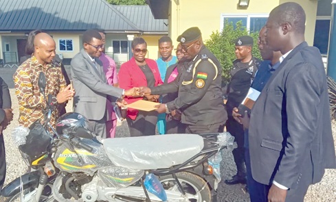Worlanyo Kojo Foster (2nd from left), National Director, Advocacy and Partnership of IJM, presenting a motorbike to Felix Apedo, Assistant Commissioner of Police, Ashanti North Regional Police Commander, after the inauguration of the anti-human trafficking unit