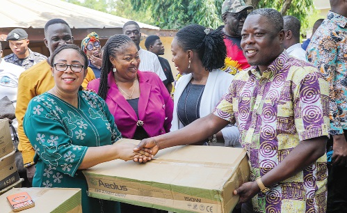 Linda Obenewaa Akweley Ocloo (left), Greater Accra Regional Minister, presenting the street lights to Raphael Nartey (right), Municipal Chief Executive, Ningo Prampram