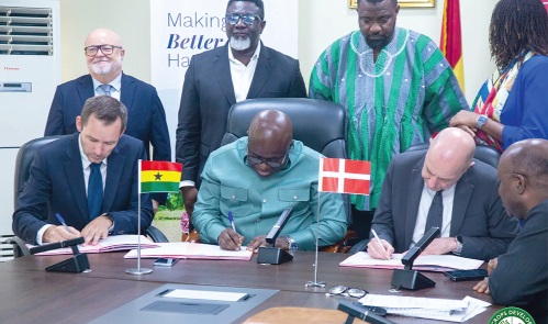Eric Opoku (2nd left), Food and Agric Minister, and Lasse Skaksen (left), Vice President and Head of AAK West Africa, signing the MoU, while Jakob Linulf (right), Ambassador of Denmark to Ghana, witnesses the signing with other officials looking on