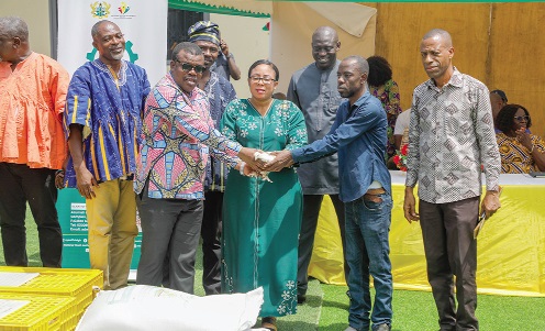 Linda Obenewaa Akweley Ocloo (middle), Greater Accra Regional Minister, being assisted by Bright Demordzi  (2nd from left), National Coordinator of the Feed  Ghana Programme, to hand over the fowls to the Accra Metropolitan Assembly. Picturs: ELVIS NII NOI DOWUONA 