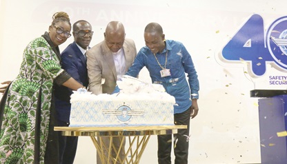 Joseph Bukari Nikpe (2nd from right), Minister of Transport, being assisted by Rev. Stephen Wilfred Arthur (right), Director-General, GCAA; Yvonne Nana Afriyie Opare (left), Managing Director, Ghana Airports Company Limited, and  Simon Allotey, Board Chair, to cut the cake