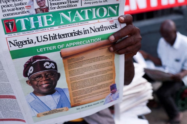 People read newspapers reporting on U.S. airstrikes against Islamic State militants in Nigeria, according to U.S. President Donald Trump and the U.S. military, in Lagos, Nigeria, December 26, 2025. REUTERS/Sodiq Adelakun/File Photo