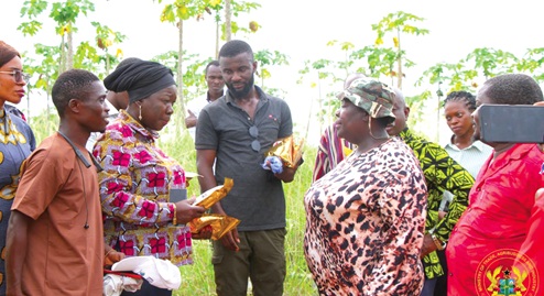 Elizabeth Ofosu-Adjare (2nd from left), Minister of Trade, Agribusiness and Industry, interacting with Prophetess Rebecca Aboagye, Founder and President of Nyonkodo Farmers Association, during the visit to the farm