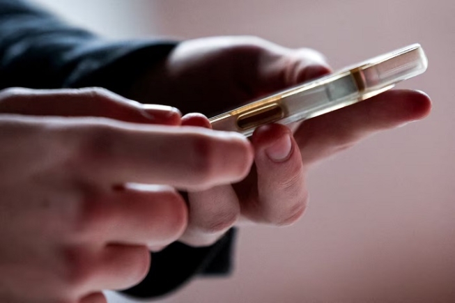 A 16 year old uses his phone, in Madrid, Spain February 3, 2026. REUTERS/Violeta Santos Moura/File Photo