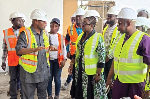 Rev. Solomon Adjasoo Abijah (left), Director of Projects, Engineering and Construction, Mawums Limited, providing updates on the project to James Agalga (right), Board Chairman, GACL, and other members of the GACL board during the visit to the project site