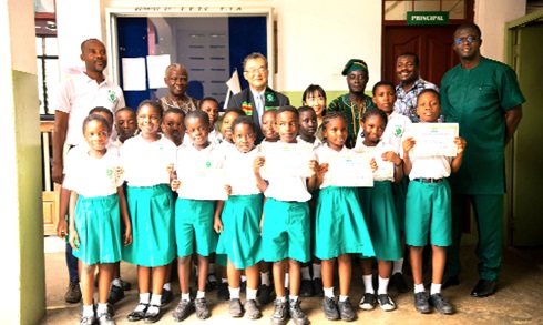 Officials from the Japanese Embassy and management of the school with some of the pupils after the visit