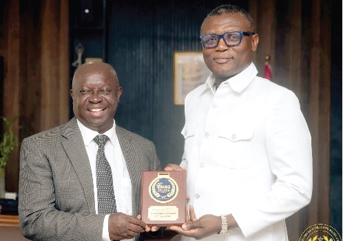 Kofi Adams (right), Minister of Sports and Recreation, and Kwabena Yeboah, President of SWAG, displaying an award shield