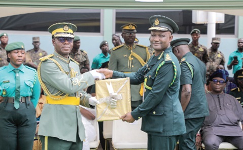 Samuel Basintale Amadu (left), Comptroller-General, Ghana Immigration Service, presenting a certificate of discharge to Laud Ofori Affrifah, outgoing Deputy Comptroller-General, Ghana Immigration Service, during the pull-out ceremony. Picture: ELVIS NII NOI DOWUONA