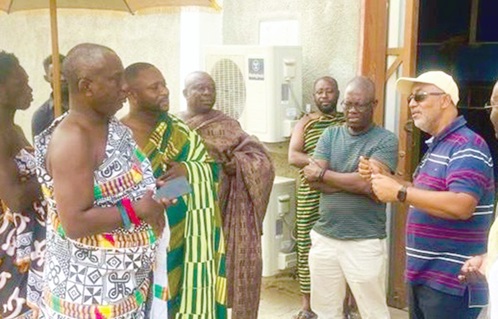 Alexander Kofi-Mensah Mould (right), Chief Executive,  MiDA, and the delegation interacting with Daasebre Sarfro Baah III, Chief of Worawora, during the visit