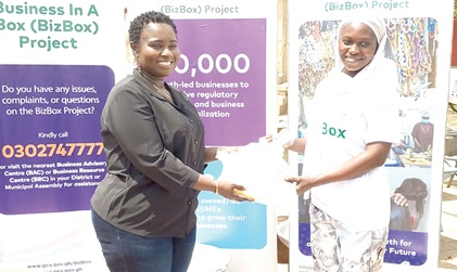 Margaret Ansei (left), CEO of Ghana Enterprise Agency, presenting tools to one of the BizBox project beneficiaries
