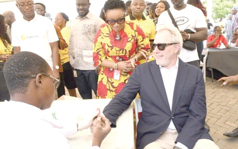 Stephen Blewett ( right), CEO of MTN Ghana, going through the screening process. Looking on includes Dr Shirley Phyllis Ohenewa (2nd from right), CEO of the National Blood Service
