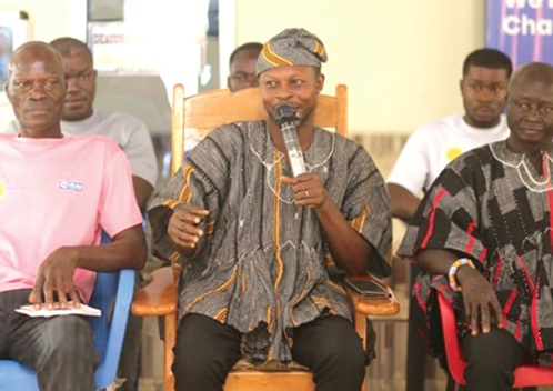 Baffour Teitey Adjewi Narh III (middle), Chief of Jato, addressing the delegation of Plan International Ghana staff and journalists. With him are some of the community leaders