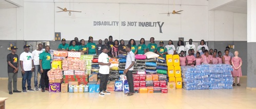 Rev. Chris Odai of ICGC The Royal Temple presenting the items to the Head Prefect of the Akropong School for the Blind.
