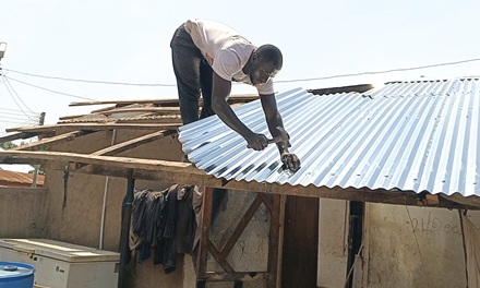 An affected person rebuilding his home after the storm
