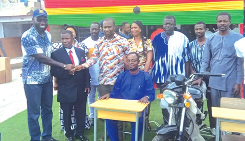 John Darko (left), Member of Parliament for Suame Constituency, making a presentation to Nurudeen Ansomah, Principal of Suame Technical Institute