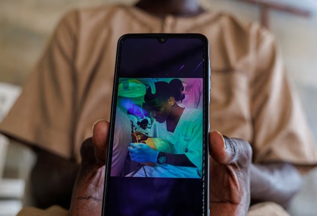 A brother of Abdoulaye Ba, a student who, according to other students, was killed at the Cheikh Anta Diop University (UCAD) campus during protests over financial aid that turned violent, shows Abdoulaye's photo on his mobile phone at their house in Dakar, Senegal, February 12, 2026. REUTERS/Zohra Bensemra