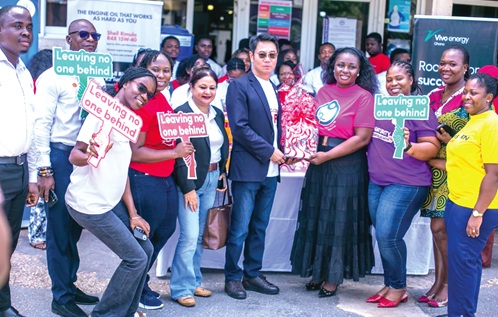 Christian Li (4th from left), Managing Director, Vivo Energy Ghana, presenting a hamper to Dr Ernestina Schandorf (4th from right), a Paediatric Oncologist at the Child Health Department, Korle Bu Teaching Hospital