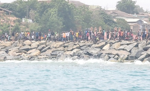 Members of the community observing as the rescue team and the crew arrive Members of the community observing as the rescue team and the crew arrive