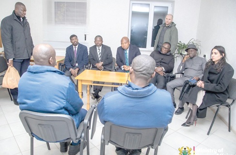 The two Ghanaian prisoners of war (seated  back to camera) with the Ghanaian delegation led by Samuel Okudzeto Ablakwa, (seated 3rd from left)