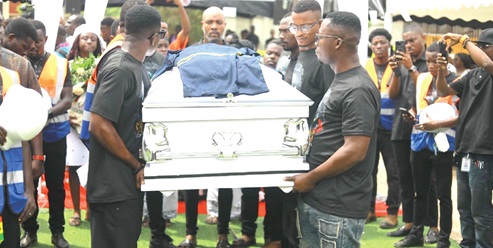 Colleagues of Charles Amissah carrying his coffin