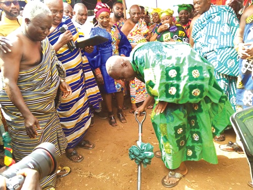 Osagyefo Oseadeeyo Agyemang Badu (with the pickaxe), President of the Bono Regional House of Chiefs, cutting the sod for the start of the project