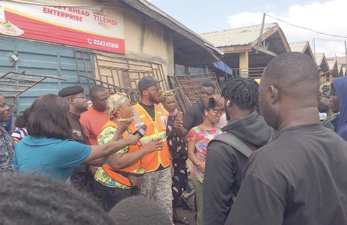 Phyllis Naa Koryoo Okunor (arrowed), Member of Parliament for Awutu Senya East, in a chat with some of the traders after the incident