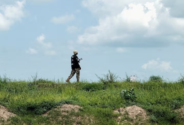 A Nigerian Army personnel stands guard as farmers return from their fields after receiving security clearance in Dikwa town, Borno State, Nigeria, August 27, 2025. REUTERS/Sodiq Adelakun/File Photo