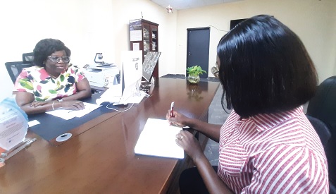 Lilian Baeka (left), Chief Director of the Greater Accra Regional Coordinating Council, explaining a point to Juliet Akyaa Safo, a Reporter with the Daily Graphic. Picture:  ESTHER ADJORKOR ADJEI
