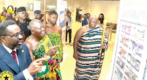 Dr Johnson Pandit Asiama (left), Governor, Bank of Ghana, leading Otumfuo Osei Tutu II (2nd from left), Asantehene, to tour some selected facilities and monuments at the Bank Square
