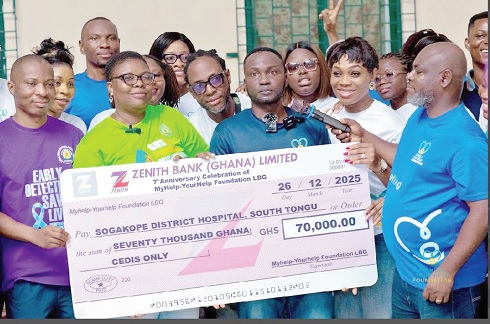 Nicholas Cofie (middle), President and Founder of MyHelp-YourHelp Foundation, presenting a dummy cheque for GH¢70,000 to staff of the Sogakope District Hospital