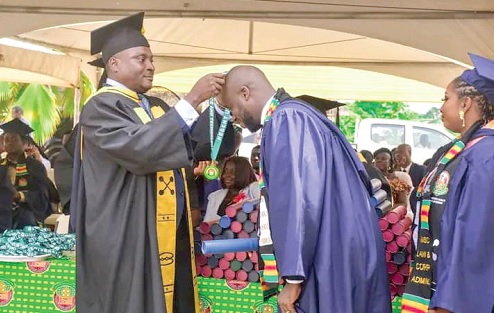One of the graduates receiving his medal at the ceremony