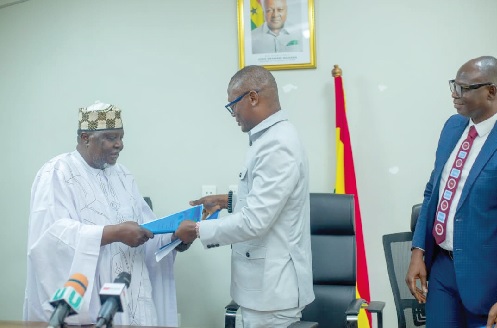 •Kofi Iddie Adams (right), Minister of Sports and Recreation, exchanging signed documents with Col. Hamad Kalkaba Malboum, CAA President, after sealing the MoU that officially launches preparations for the competition
