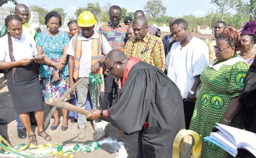 Rt Rev. Prosper Dzomeku performing the sod-cutting ceremony, while James Gunu, Volta Regional Minister and others look on