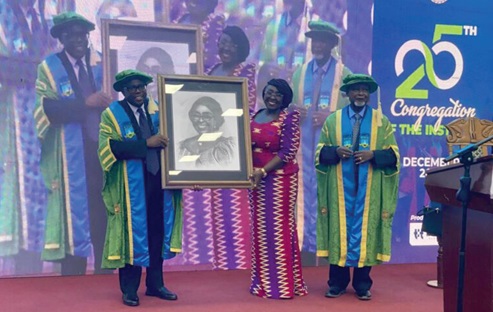 Prof. Samuel Bonsu  (left), Rector of GIMPA, presenting a portrait to Abla Dzifa Gomashie, Minister of Tourism, Culture and Creative Arts